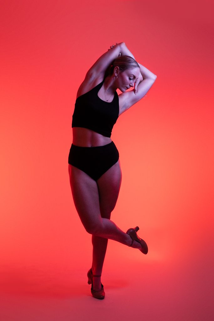 Photo of cabaret dancer in a professional photo studio with red lighting