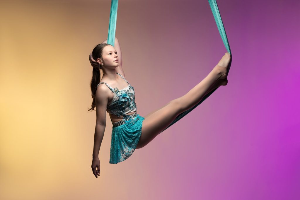 Photo of aerialist posing in a hammock